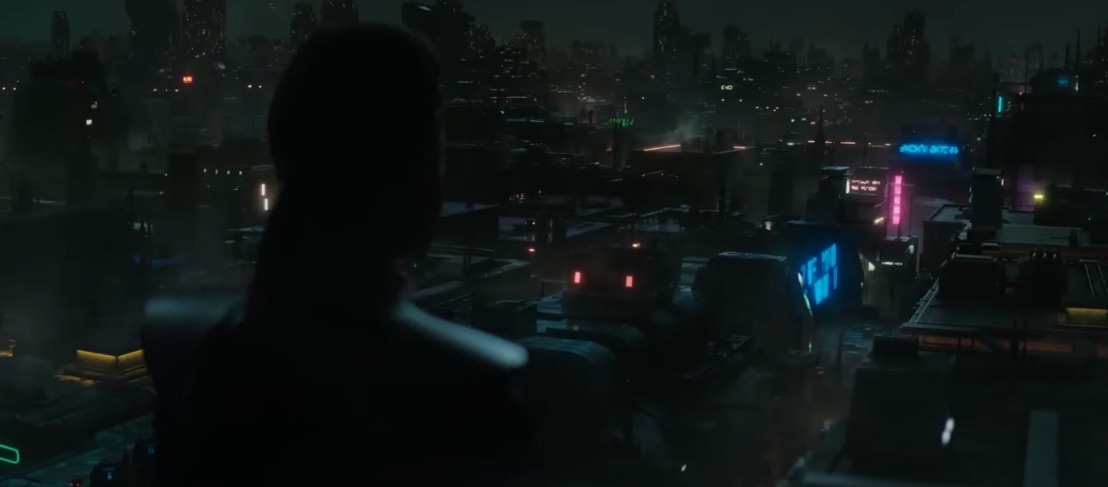 A shadowed figure overlooks a neon-lit city