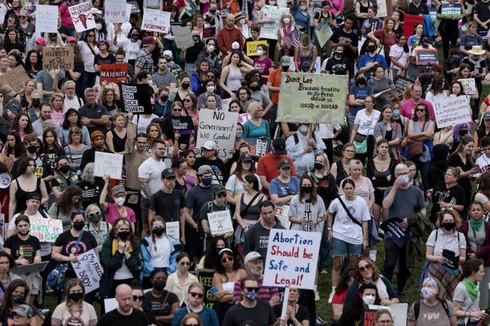 A large crowd of people, some holding signs such as &quot;Abortion should be safe and legal!&quot;