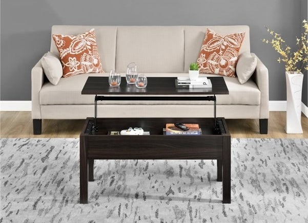 A wooden lift-top brown coffee table