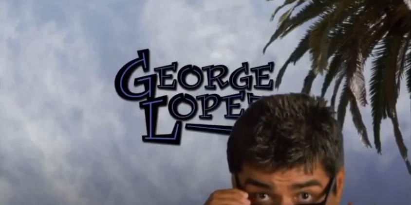 George Lopez peeks from the bottom of the screen with &quot;George Lopez&quot; title card behind him