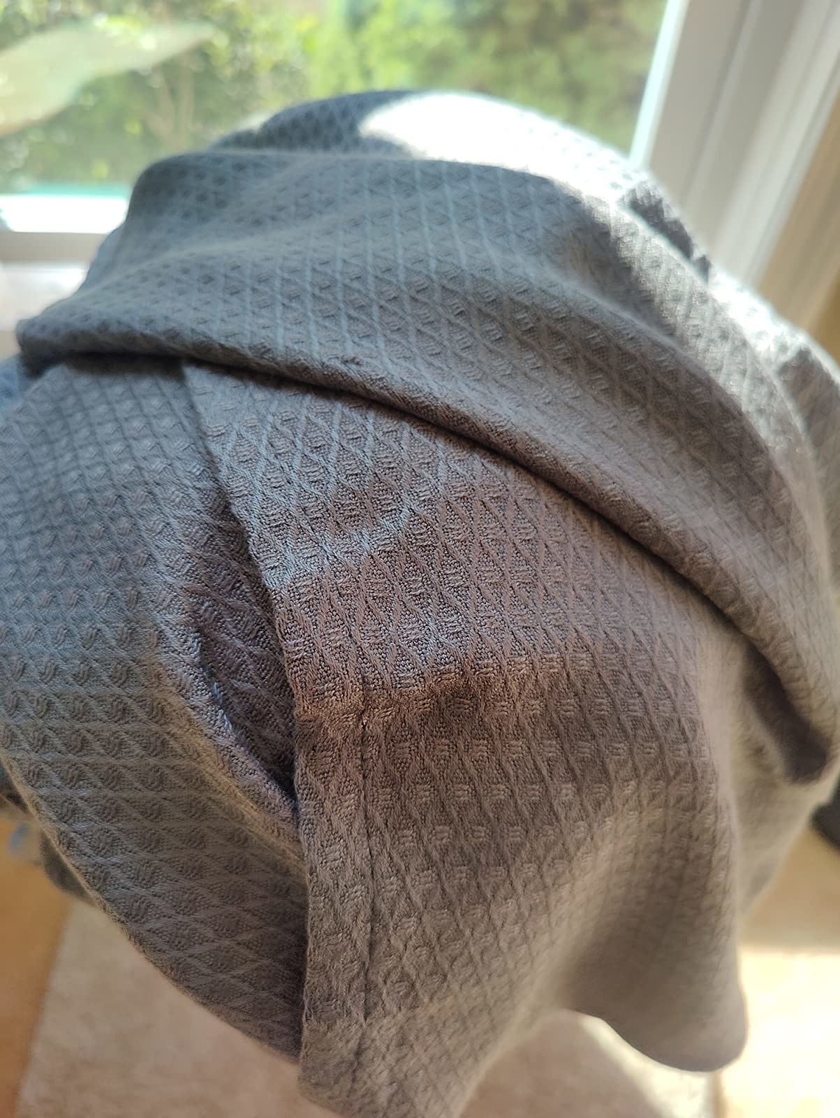 reviewer&#x27;s photo of the grey blanket up close