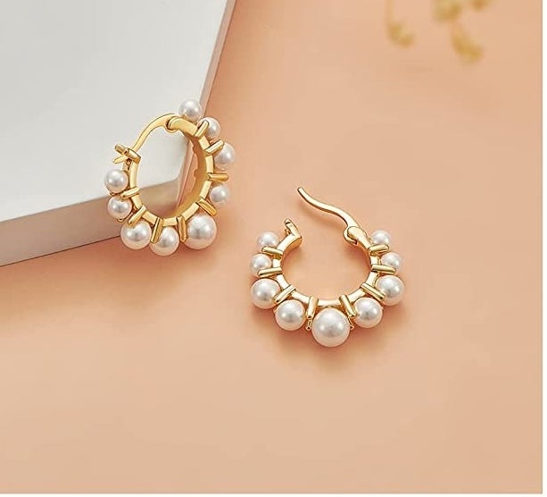 A pair of earrings on a plain background