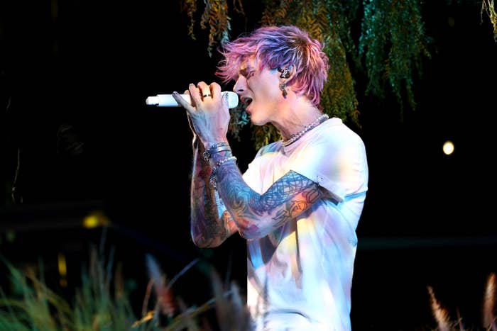 Side view of MGK singing into a microphone
