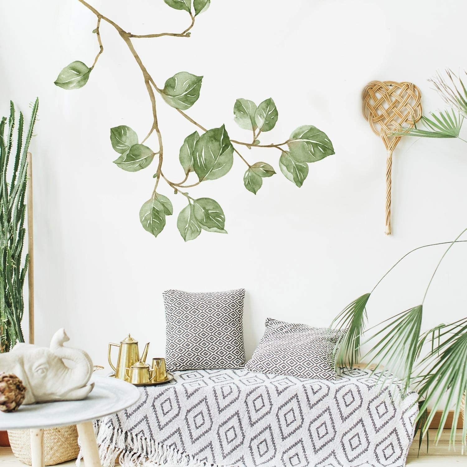 A white wall with a tree branch wall decal on it