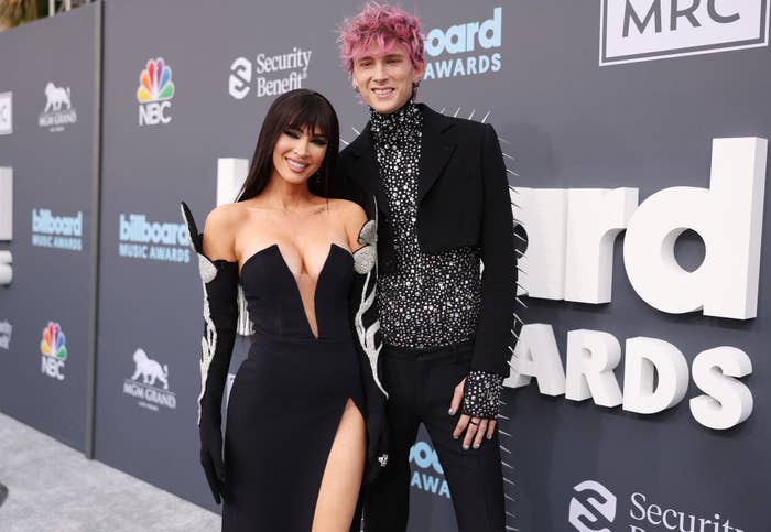 Megan and MGK smiling on the Billboard Awards red carpet