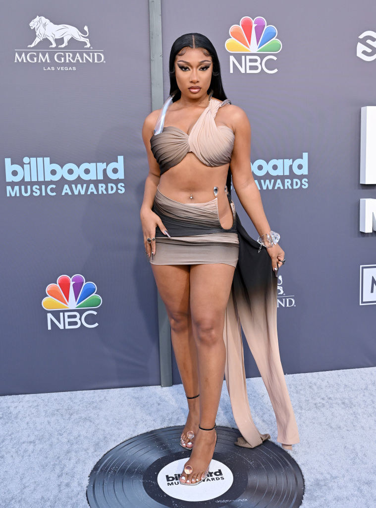 Megan Thee Stallion wearing a gray and tan two-piece dress on the BBMAs red carpet.