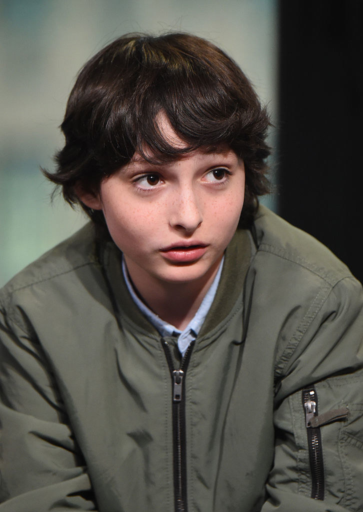 A young Finn wearing a plain green jacket