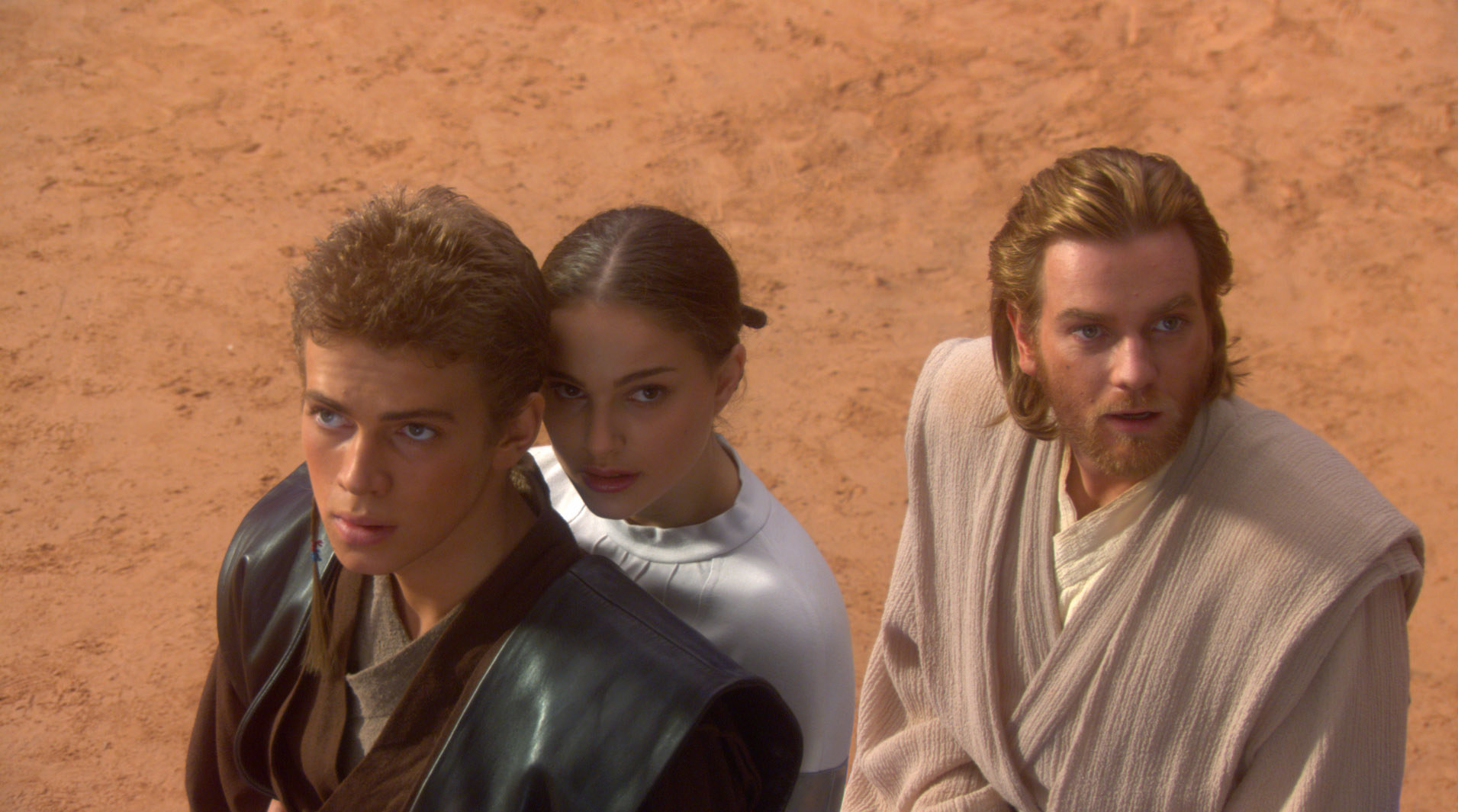 Padme holding on to Anakin with Obi-Wan behind them
