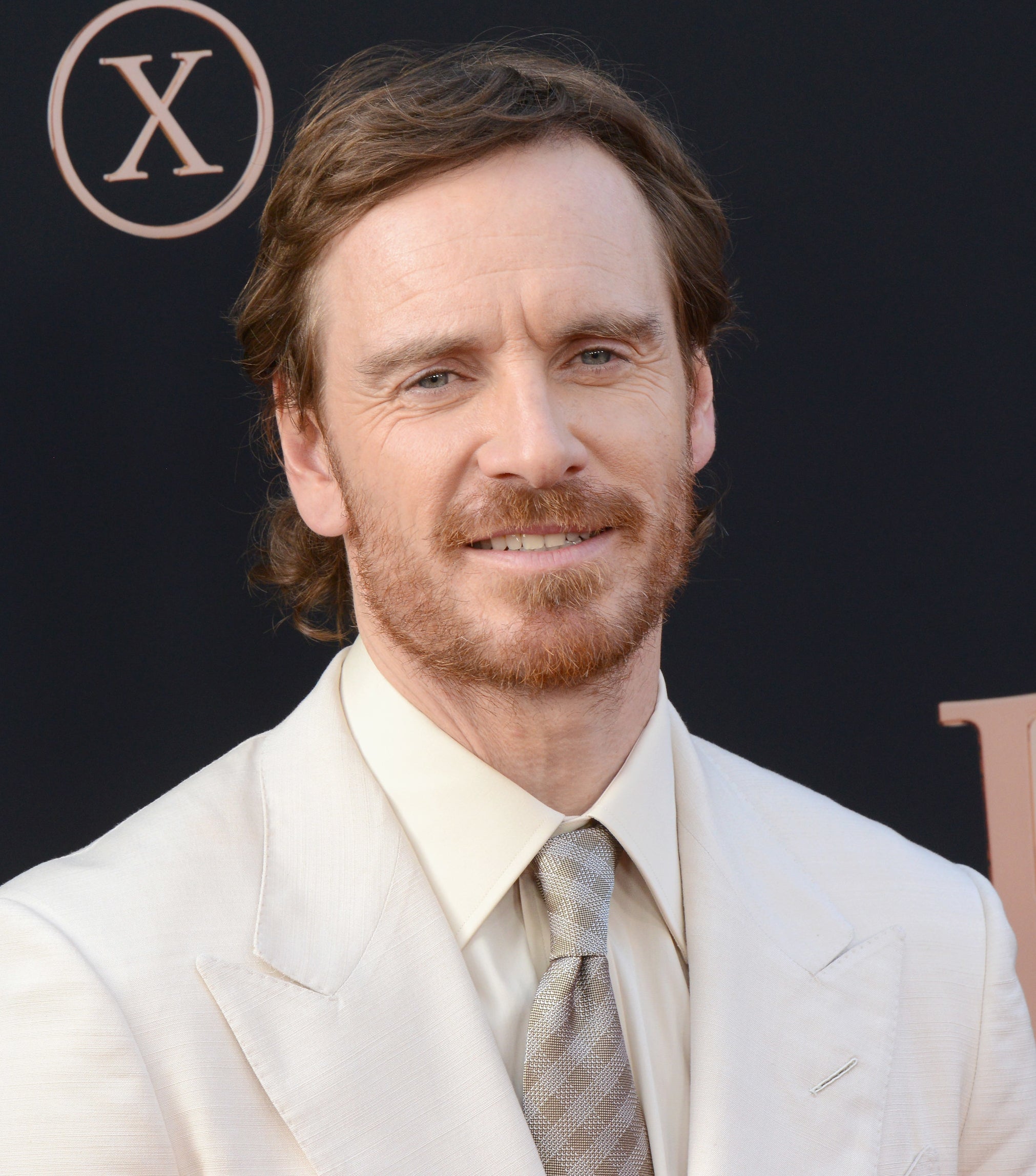 Michael Fassbender smiling at an event