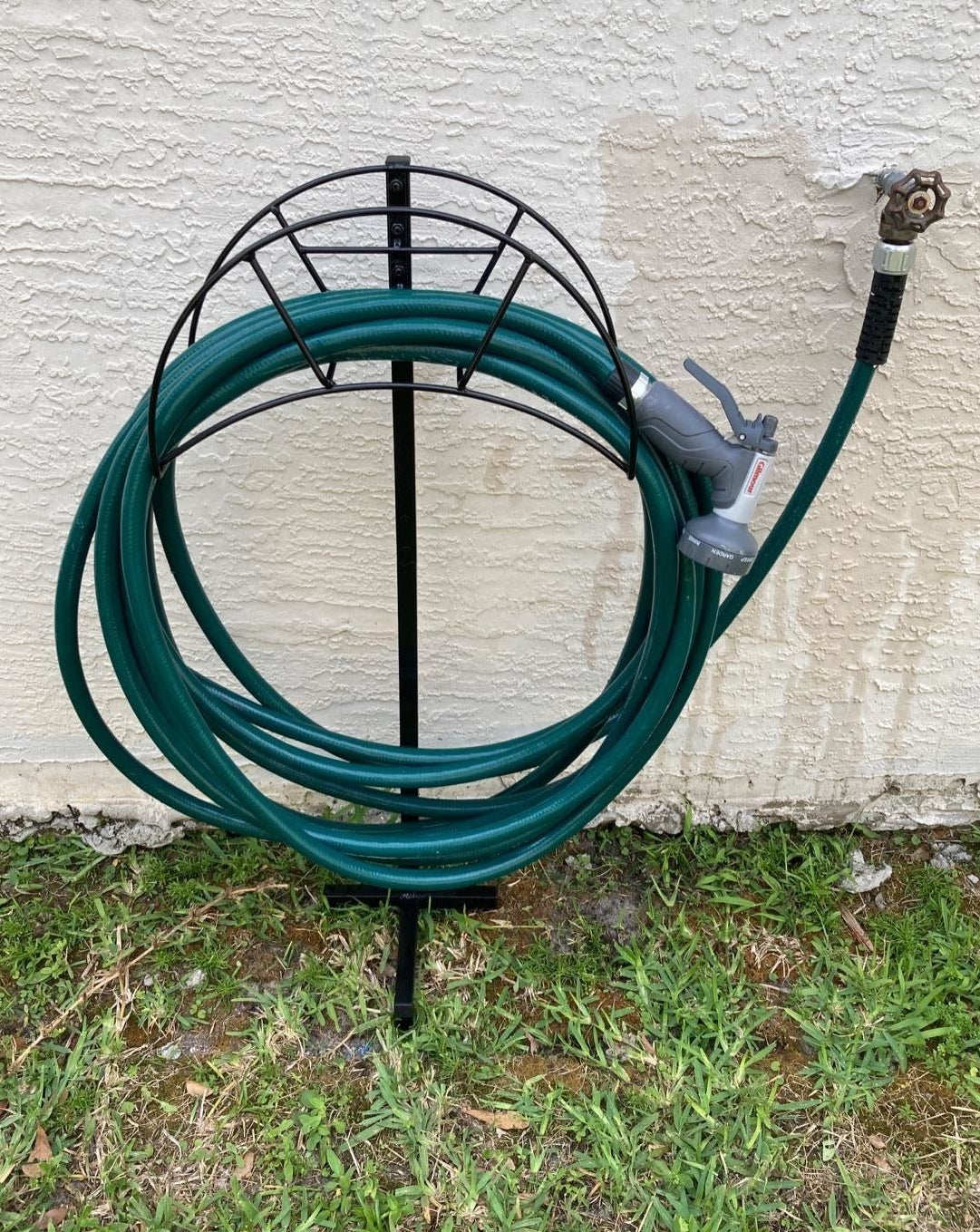 reviewer photo of a hose neatly wrapped around the hose holder