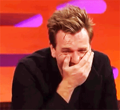 GIF of Ewan giggling and covering his mouth