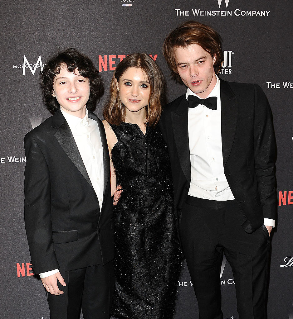 Charlie wearing a black tux with Natalia and Finn