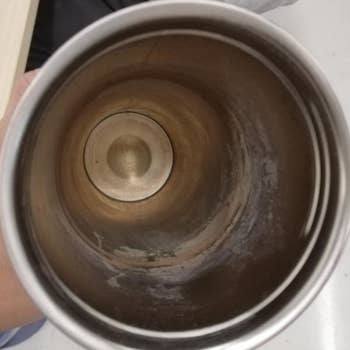 a reviewer photo of the inside of a dirty tumbler cup