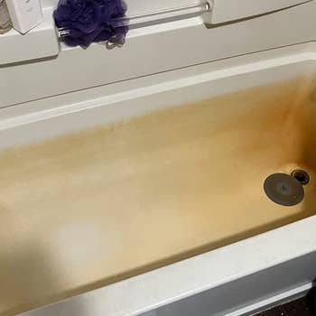a reviewer's bath tub covered in rust stains