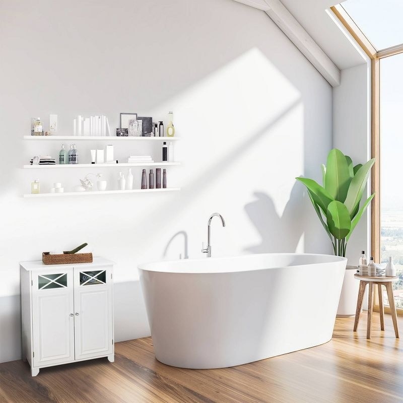 The cabinet in white next to a bathtub