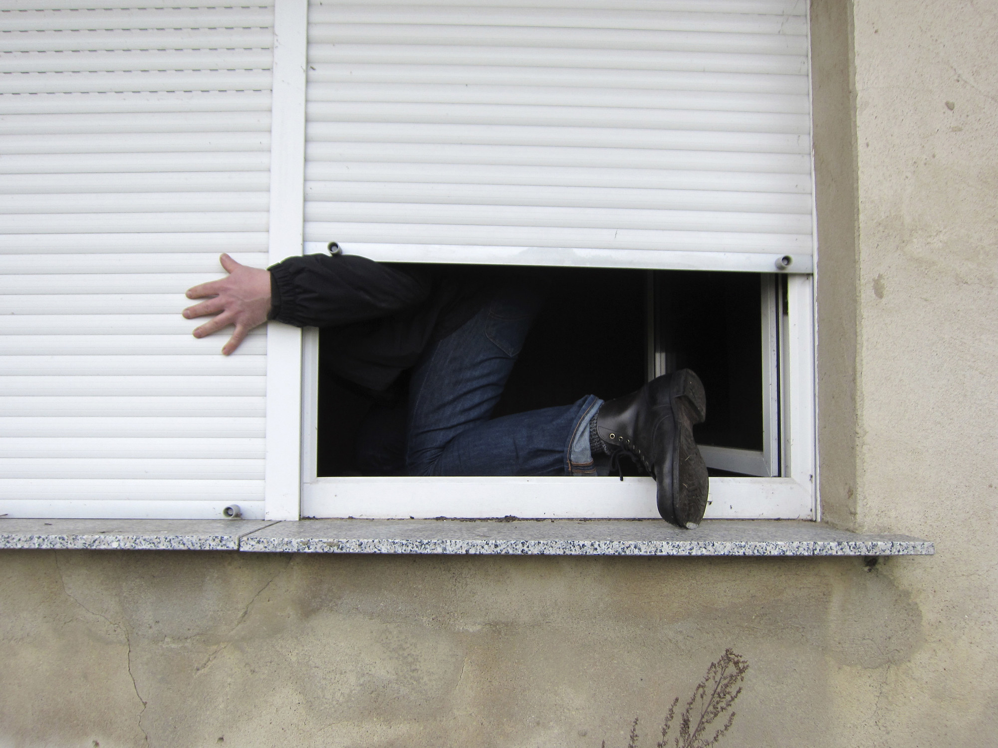 person sneaking out window