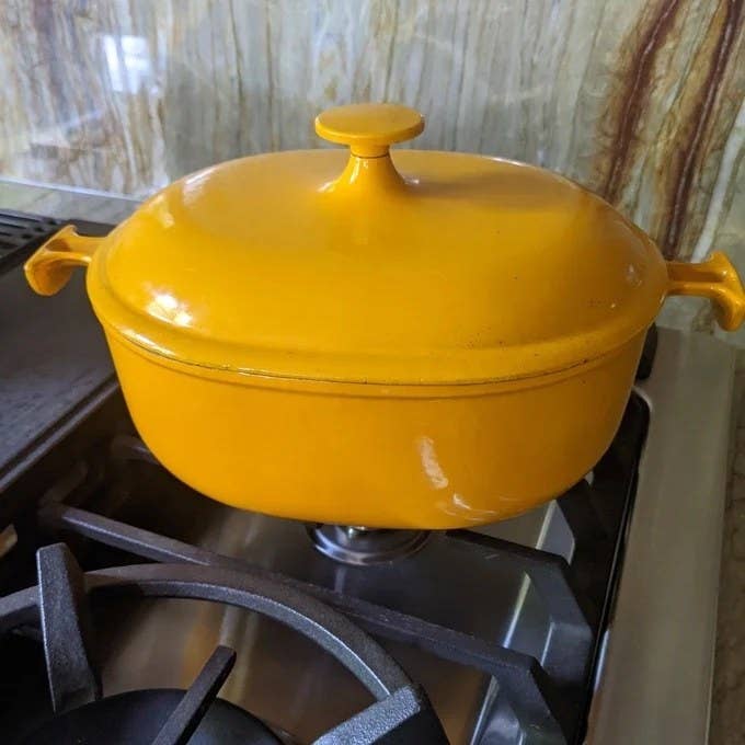 a yellow Le Creuset dutch oven on a stove
