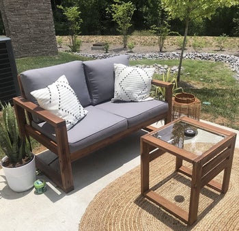 reviewer photo of the black and white pillow covers on two throw pillows on an outdoor sofa