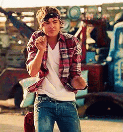 Efron moving his arms and punching the air in a dance in the film