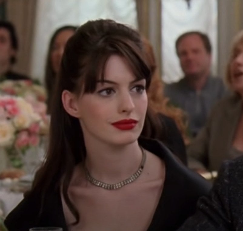 Anne Hathaway as Andy watches as Miranda snubs Nigel