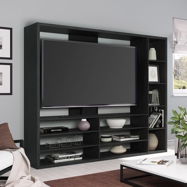 A large entertainment center with multiple shelves in black