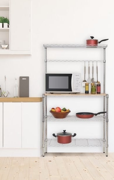 A chrome metal and wooden baker&#x27;s rack with hooks