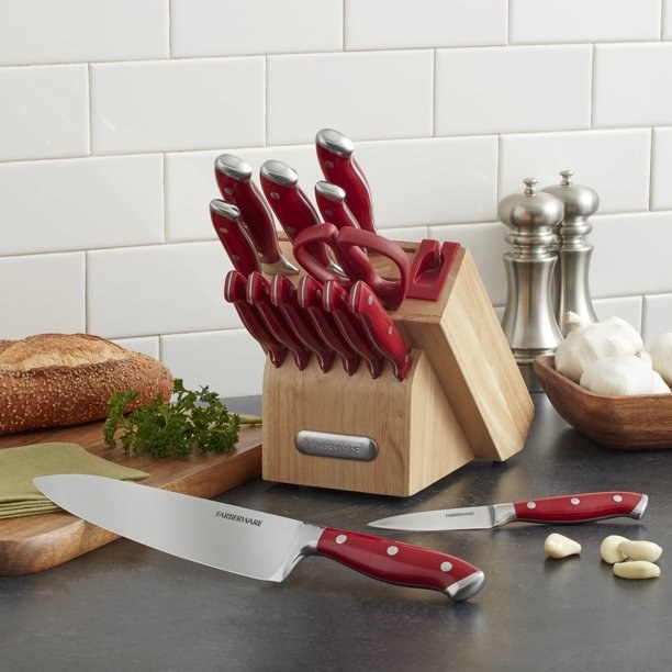The knife block with all of the knives, each has a red handle on it