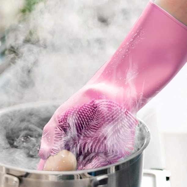 Model is grabbing an egg out of a steaming pot