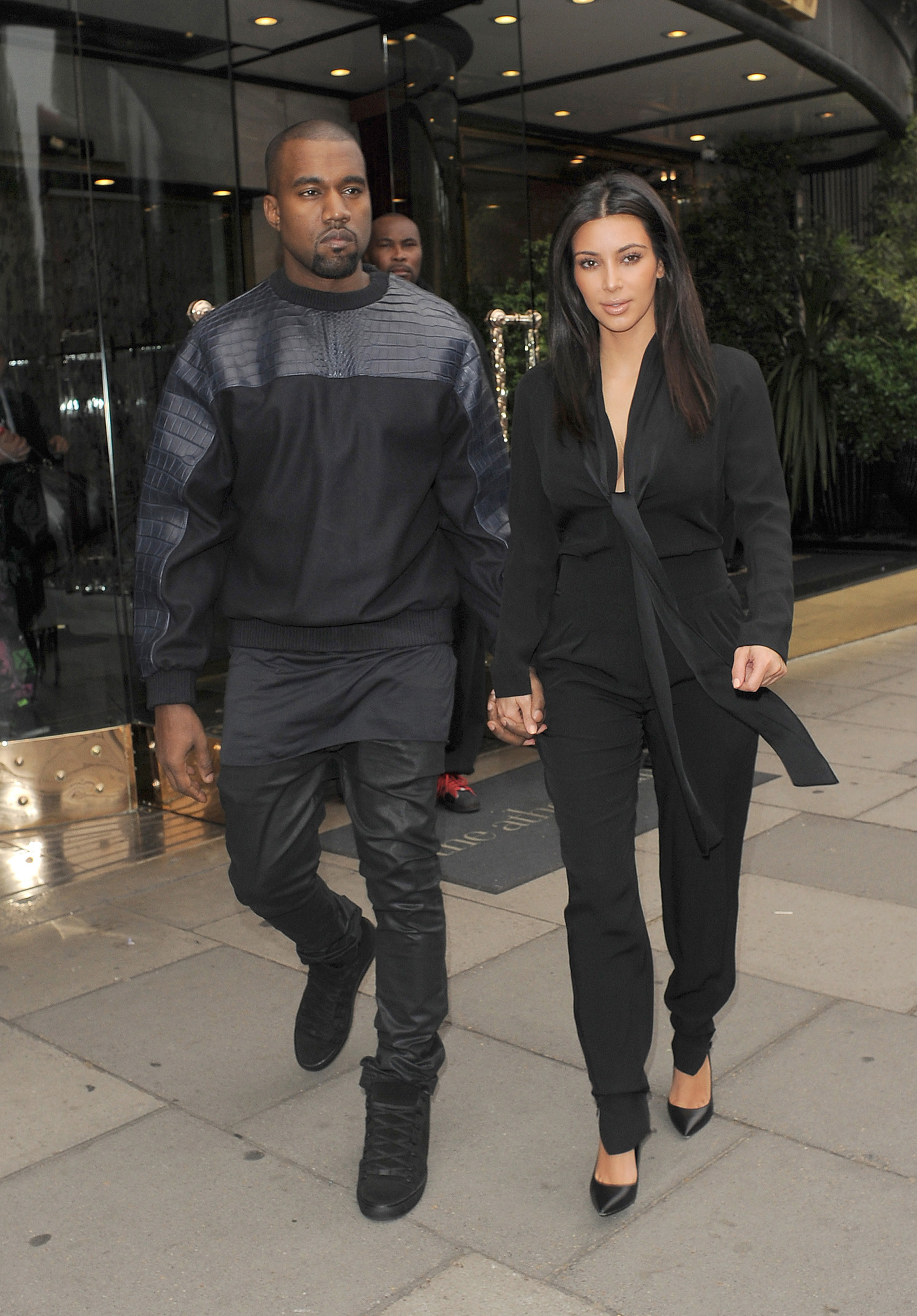 Kim and Kanye holding hands walking down the street