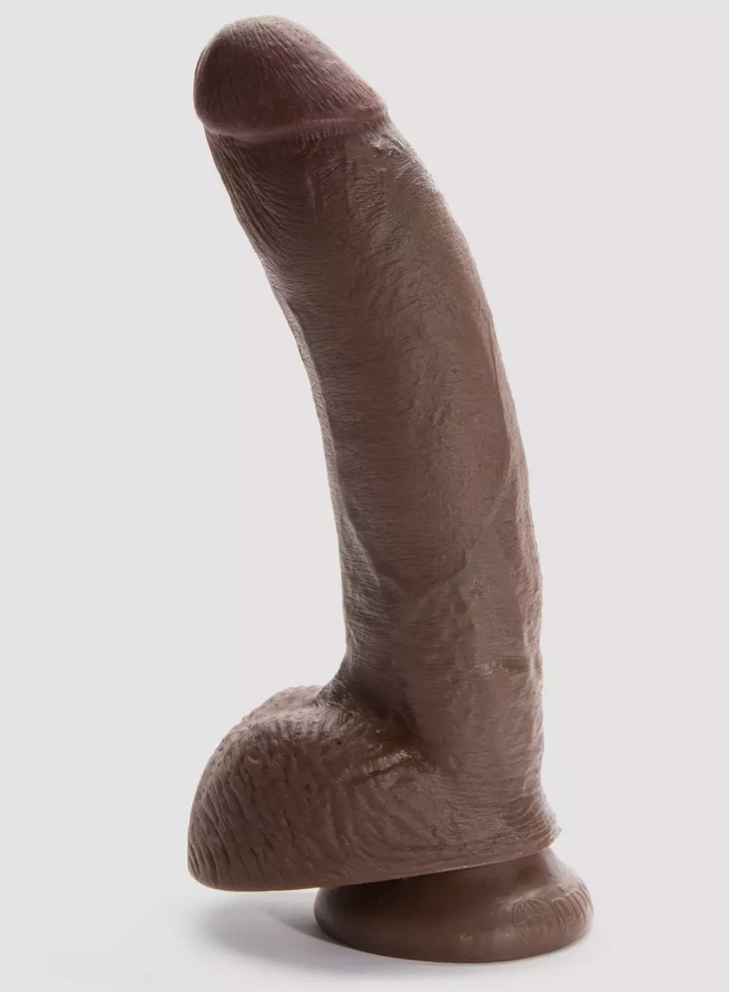 The darker brown realistic dildo with balls and suction cup at the base