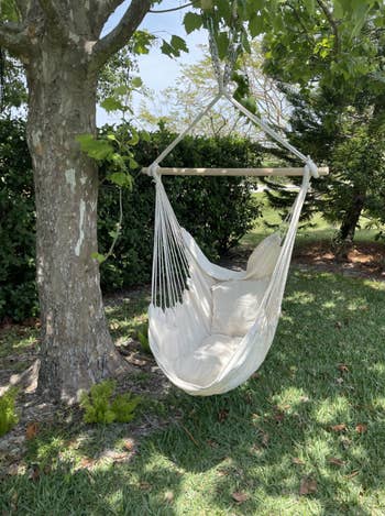 hanging white hammock chair in reviewer's backyard