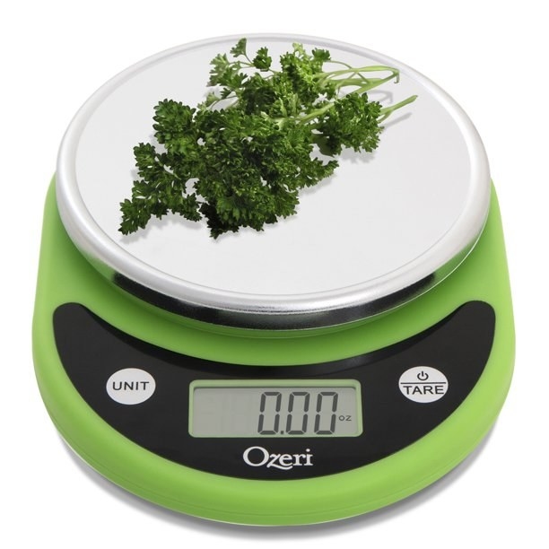 The food scale in green with herbs on top