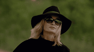 GIF woman flicking a lit cigarette