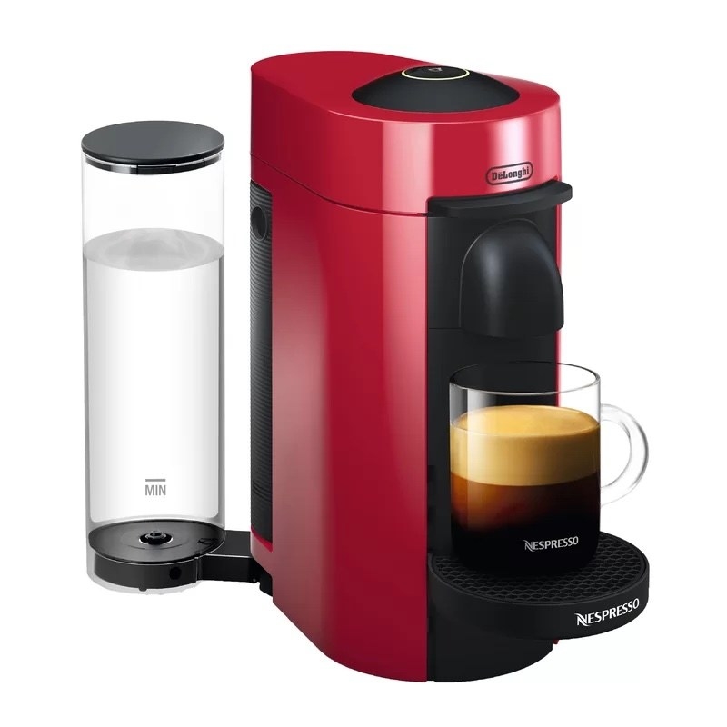 A red coffee maker with a cup of coffee