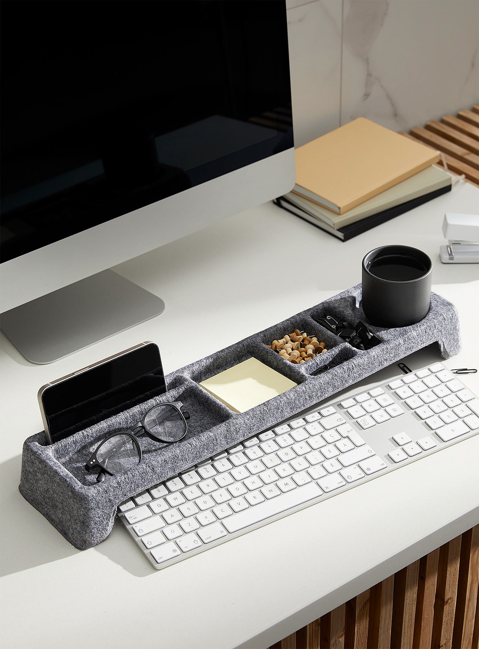 a felt desk organizer perched next to a keyboard
