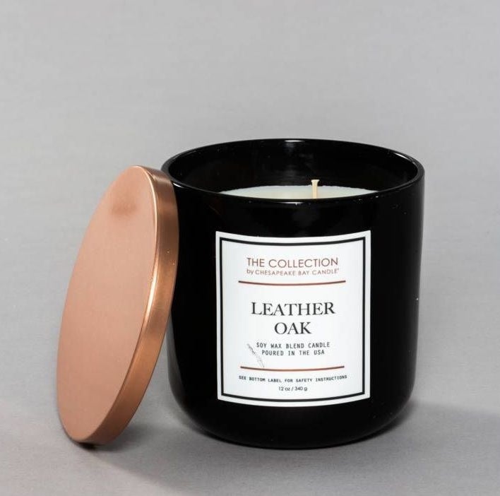the long burning leather and oak scented soy candle in a glass jar