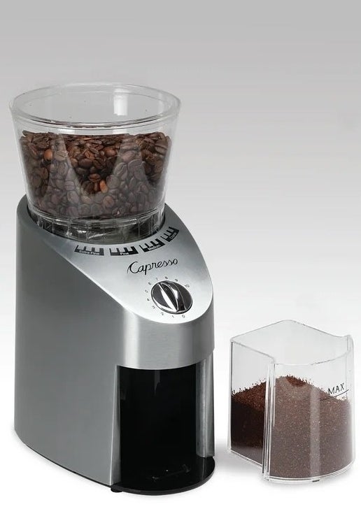 A silver coffee grinder with coffee