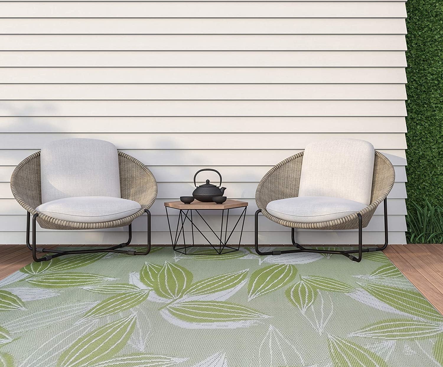 a patterned outdoor rug on a deck with two lounge chairs