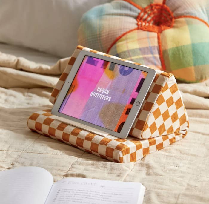 A tablet on the pillow on a bed