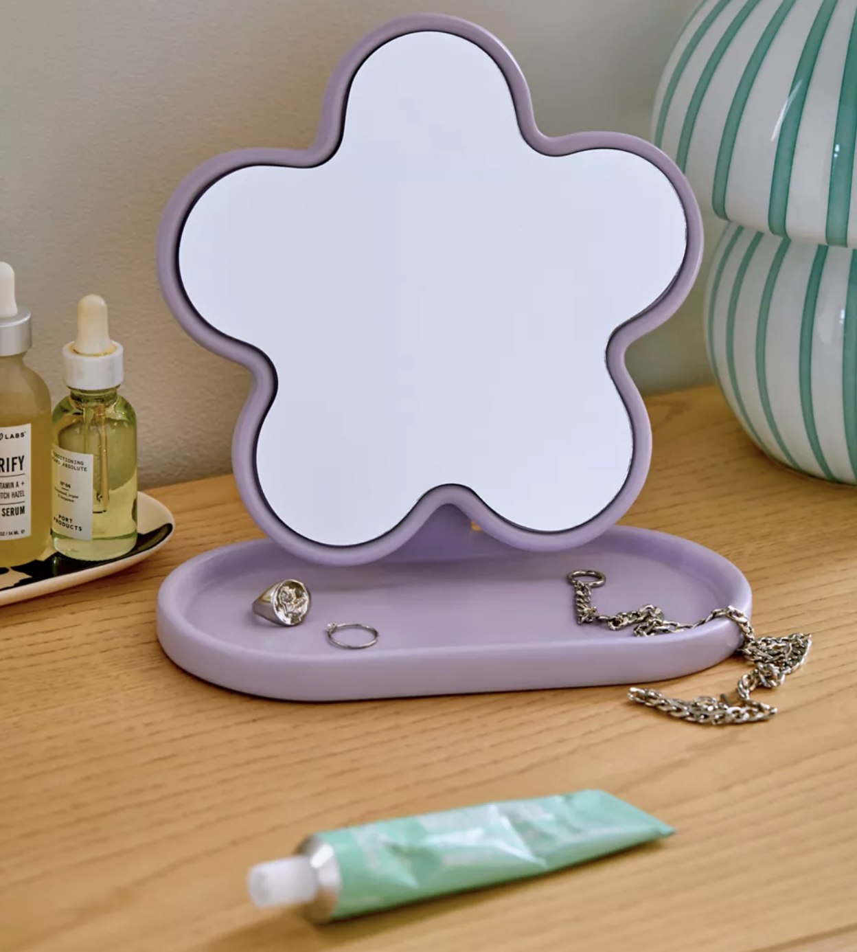 The mirror on a vanity with jewellery in its catchall dish