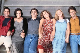 the friends cast laying down on a new york stoop together