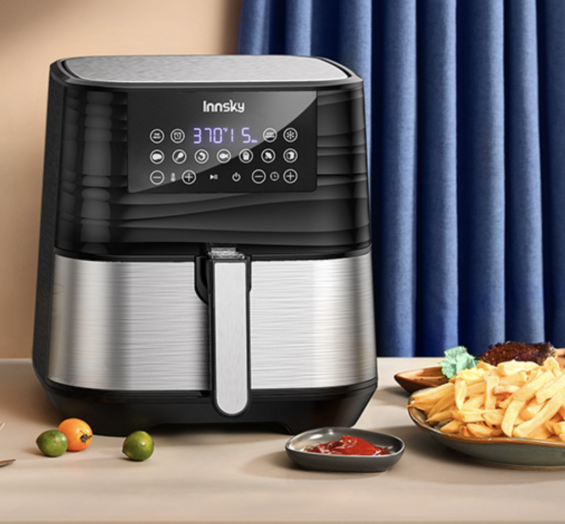 The air fryer set to 370°F next to a plate of fries and ketchup