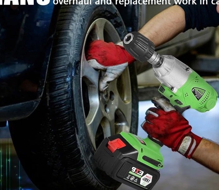 Model using green and black tool on car tire