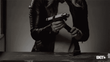 woman reloading and cocking a gun