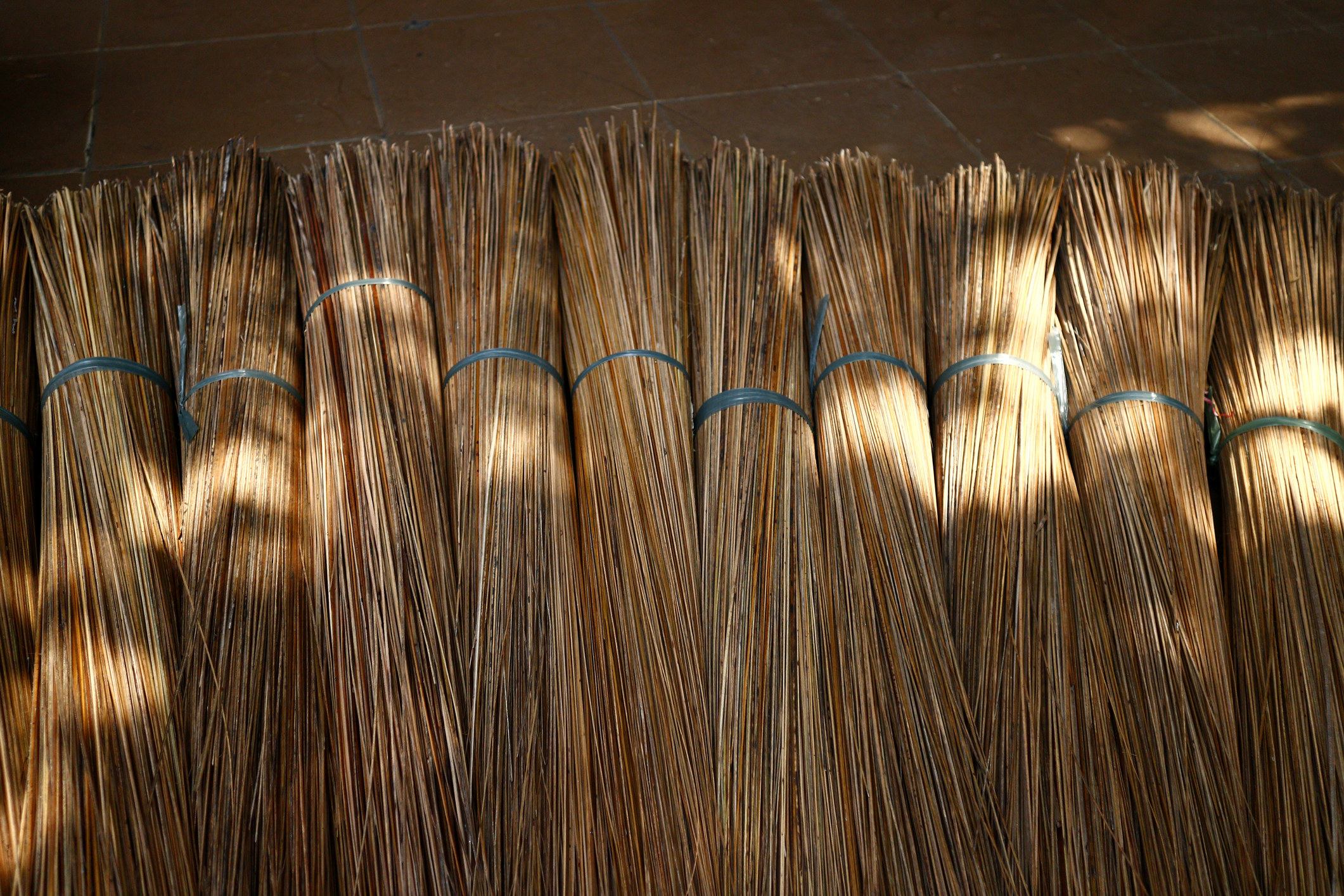 A stack of stick brooms