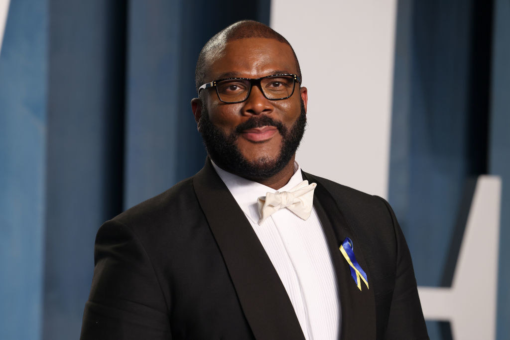 Tyler Perry smiles and wears a tux
