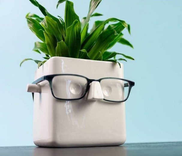 the white planter with a pair of glasses on the nose