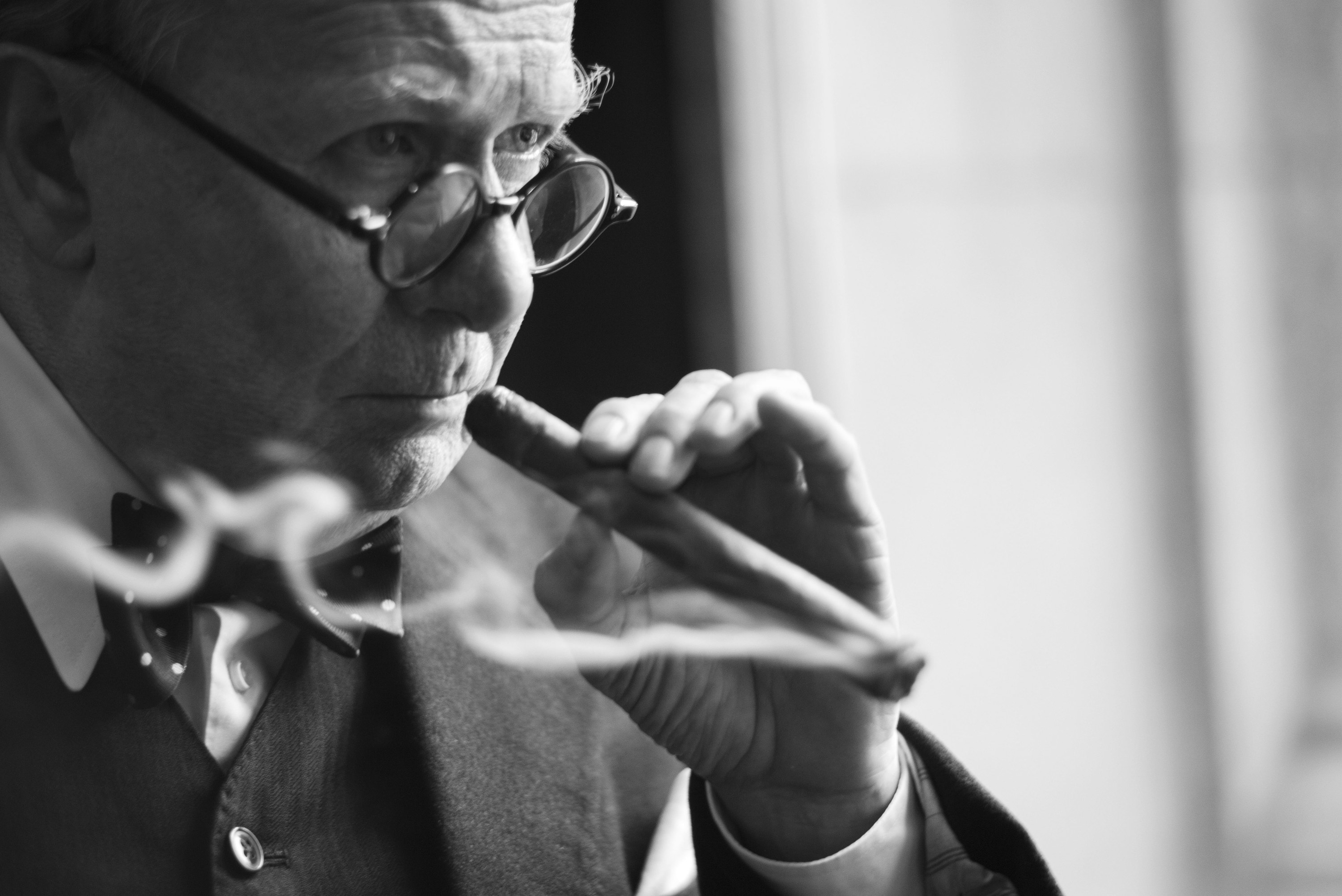 close up of Oldman smoking a cigar