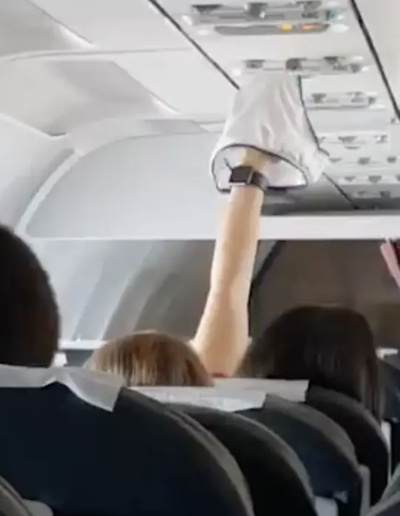 A person raising their underwear on a flight