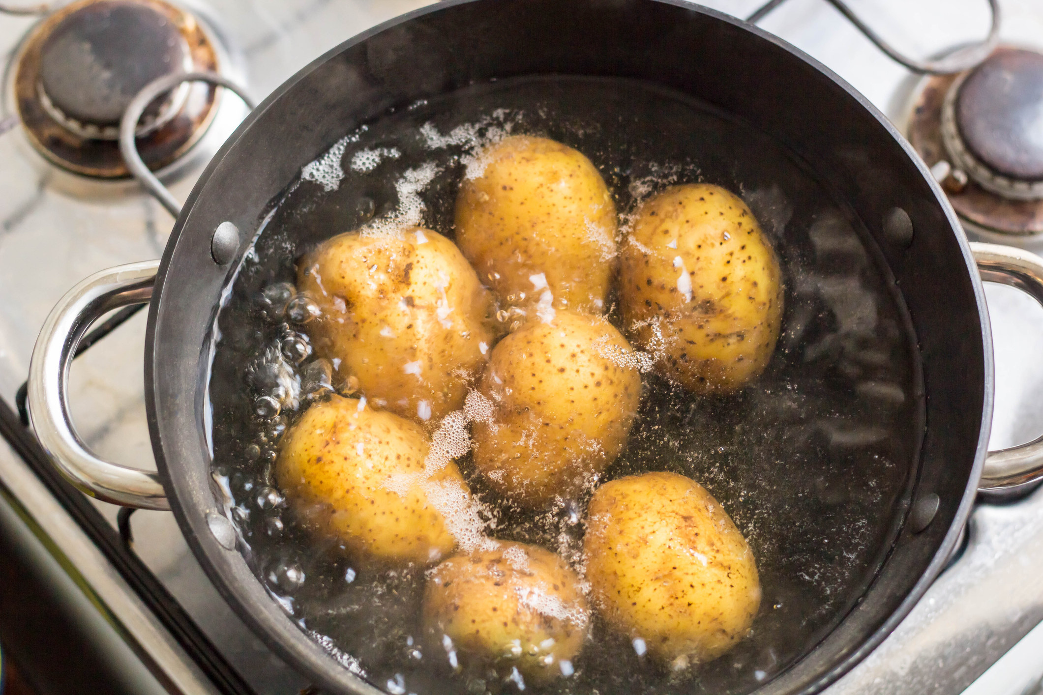 Potatoes boiling in a pot of water